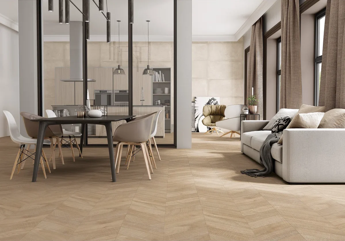 An open living and dining room with chevron wood floors