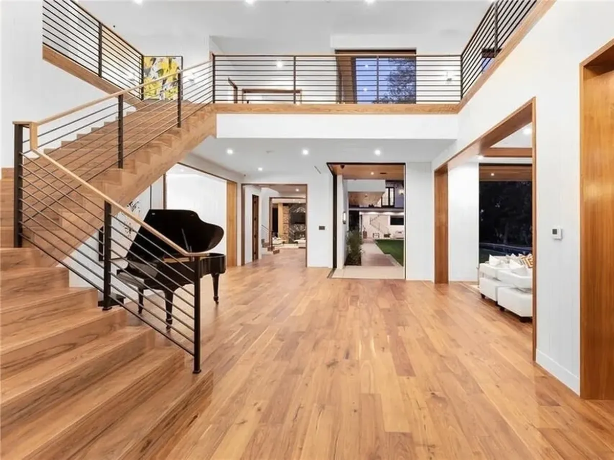 An entry and staircase with hardwood floors throughout