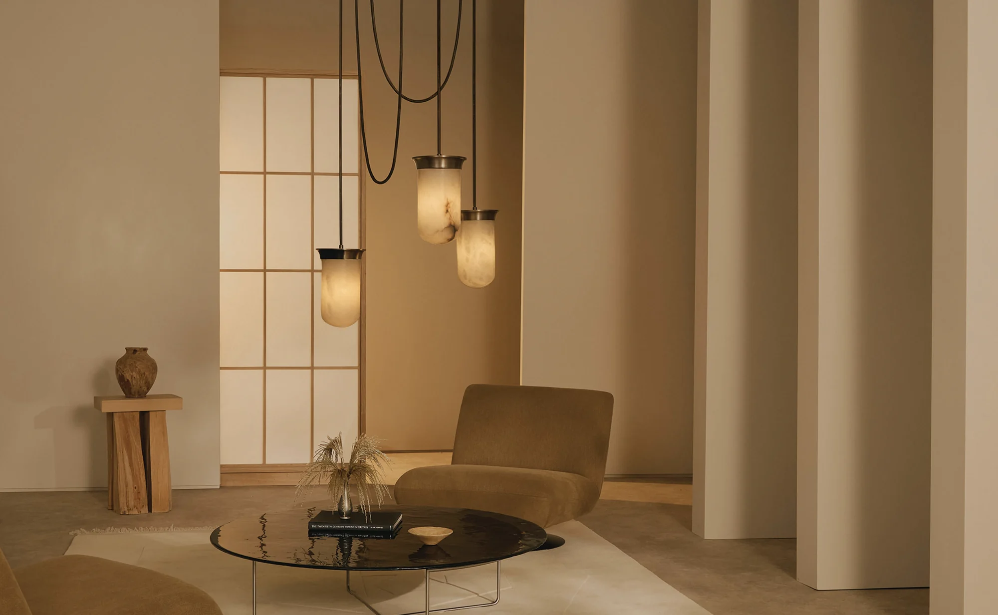 A neutral living room with three alabaster pendant lights
